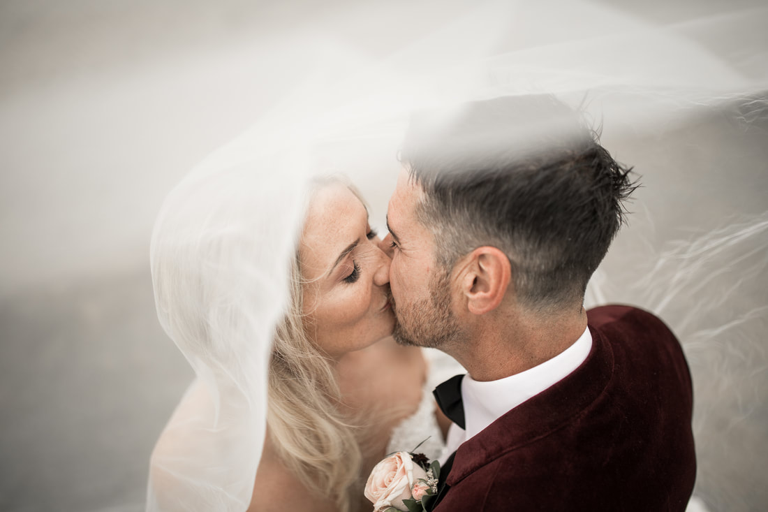 Bride and groom kissing. Award winning wedding videographer and photographer in Ireland