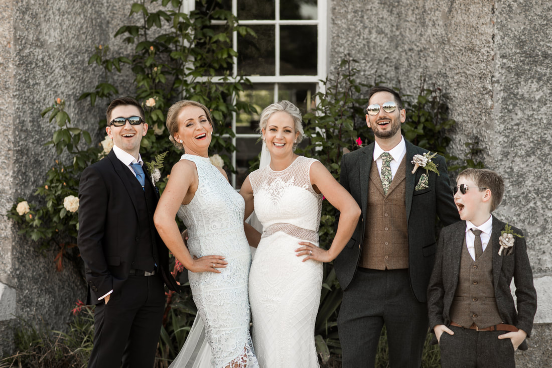 Fun and relaxed Wedding group shot at Bellingham castle