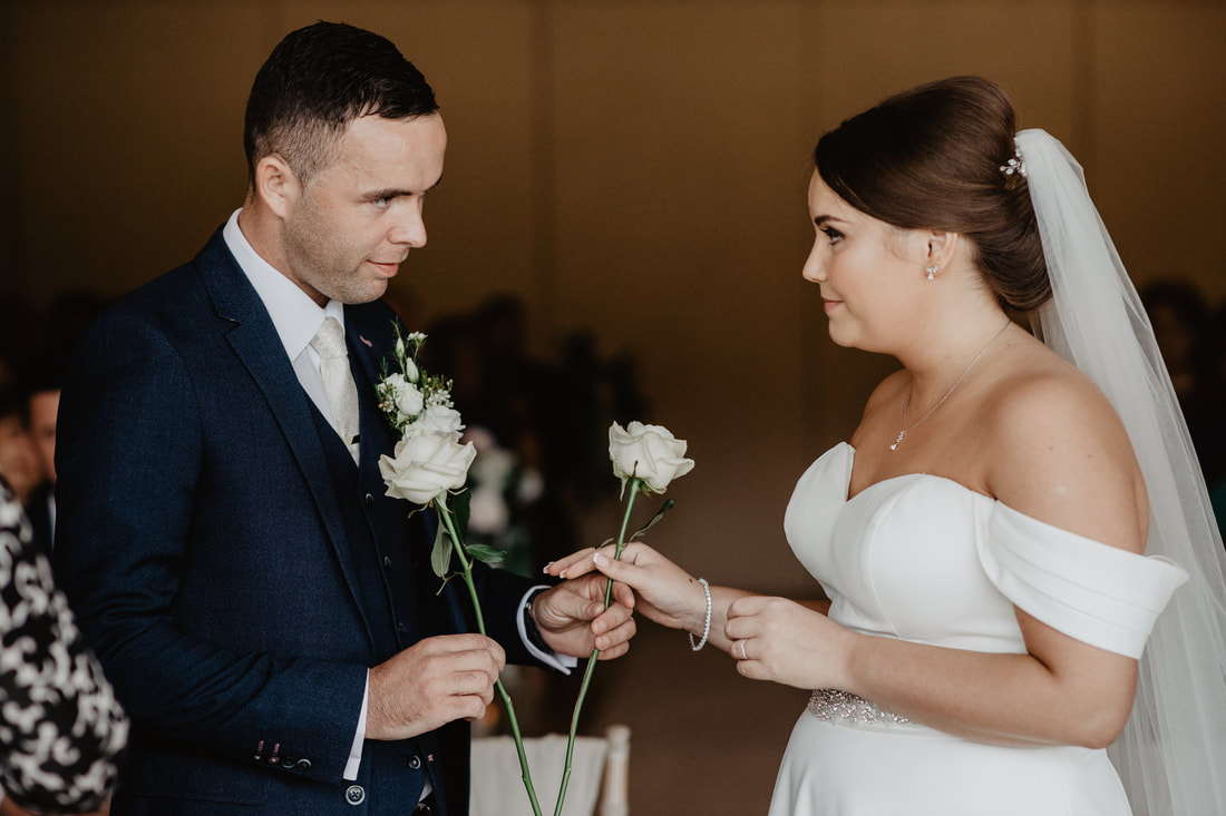 Wedding ceremony tradition with 2 white roses at Clanard Court Hotel, Athy, Co. Kildare by wedding photographer Mario Vaitkus